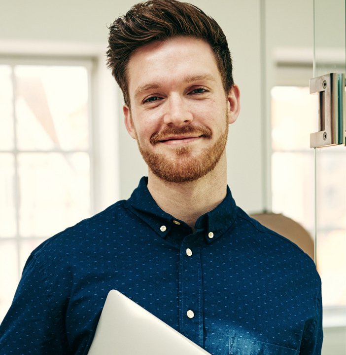 smiling-young-businessman-standing-with-his.jpg