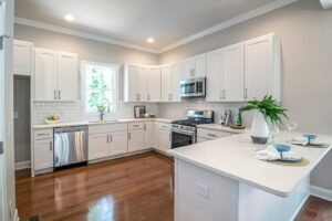 hardwood floor in kitchen with white cabinets